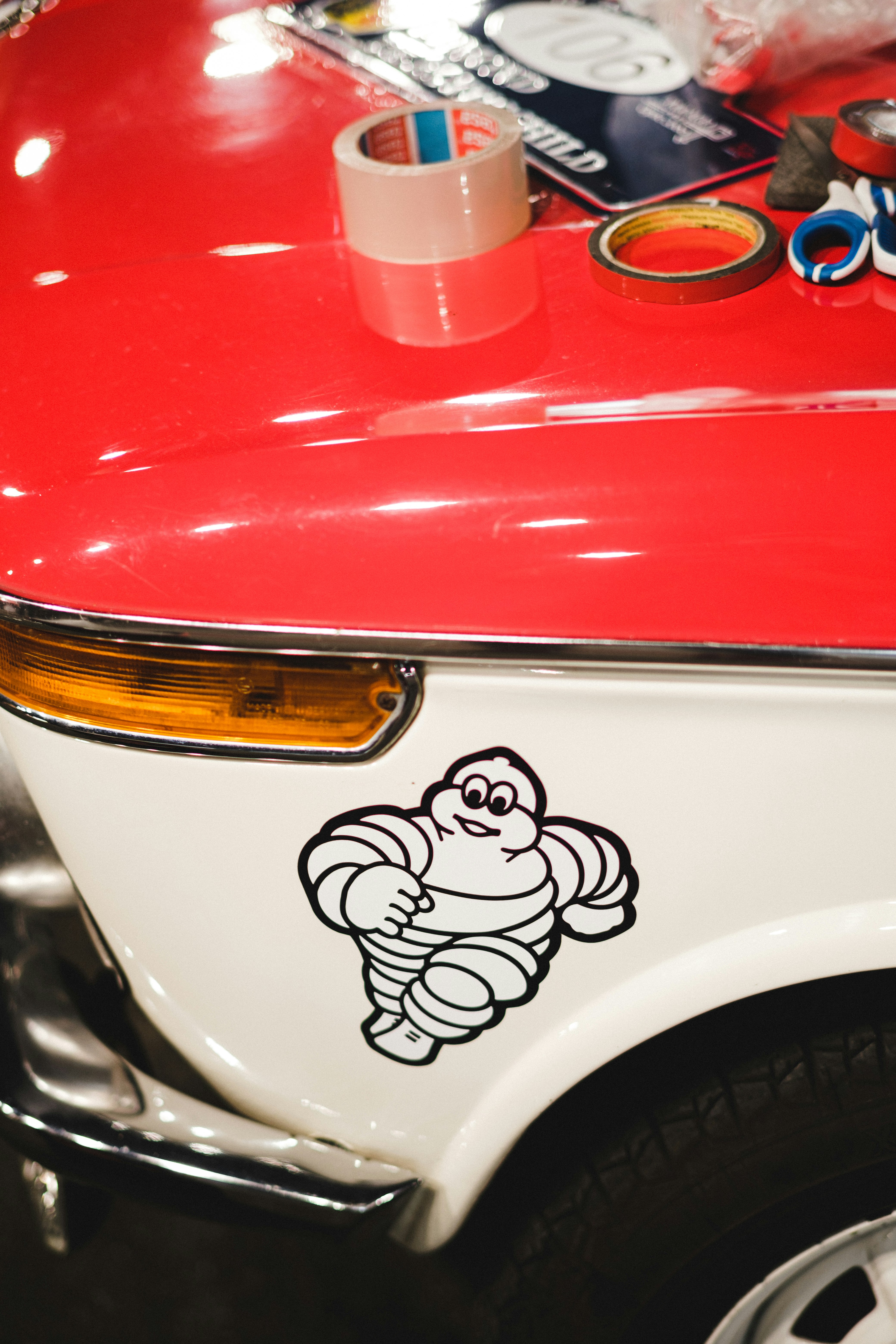 white and red car with white and black cat sticker